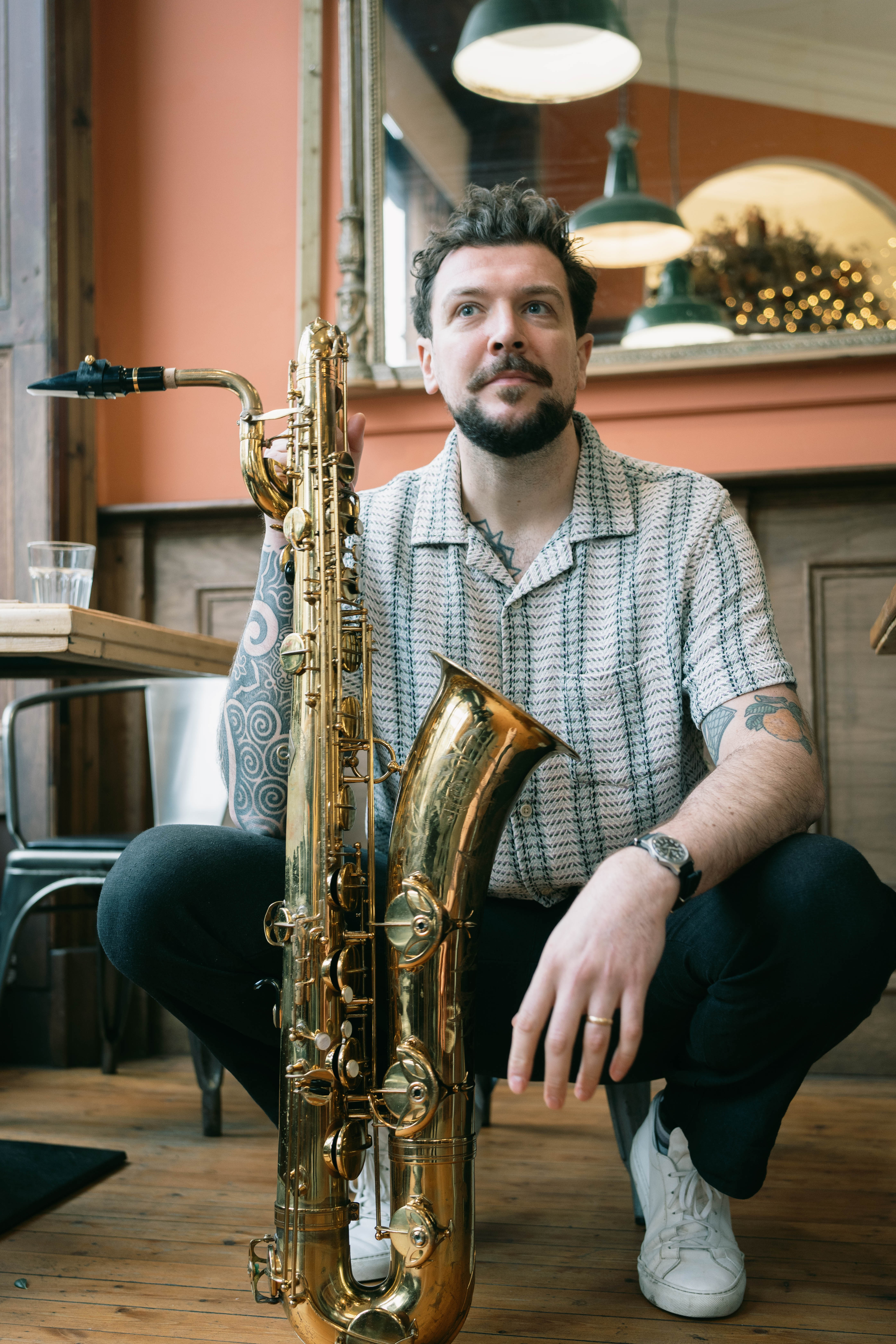 Josh performing with a baritone saxophone at an event